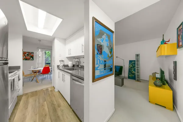 a living room with furniture a flat screen tv and a floor to ceiling window