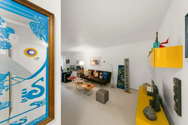 a view of room with floor to ceiling window and wooden fence