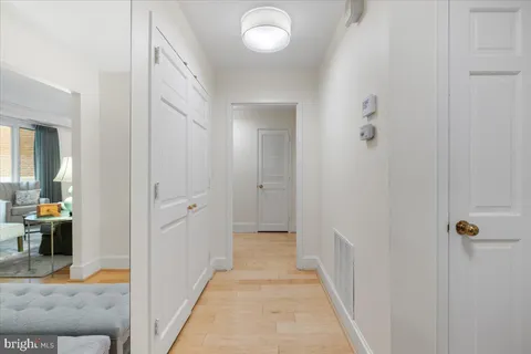a bedroom with a bed and a lamp on table