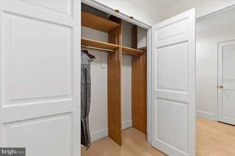 a bedroom with a bed and a flat tv screen
