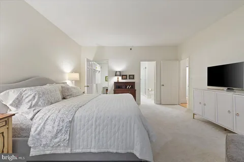 a view of a hallway with entryway wooden floor and front door