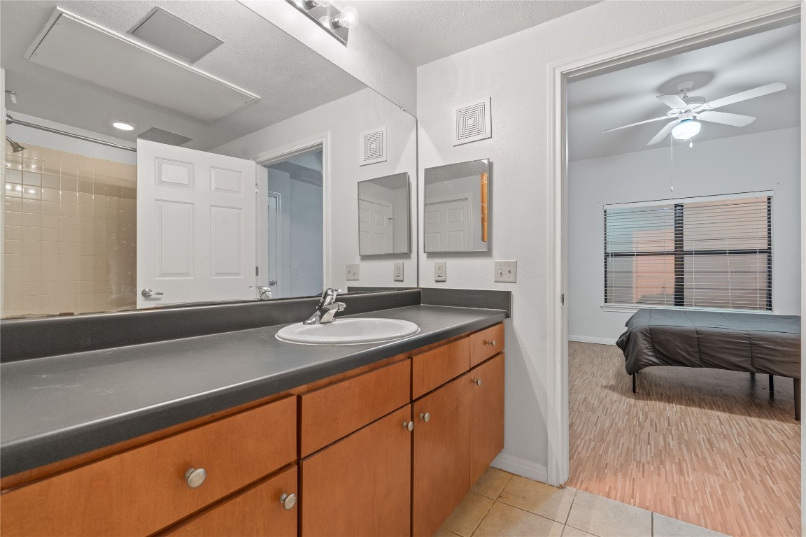 2515 Pearl Street, Unit 508 Austin, TX 78705 - Photo 11 of 25 Full bathroom with vanity, a ceiling fan, light tile patterned floors, and ensuite bath