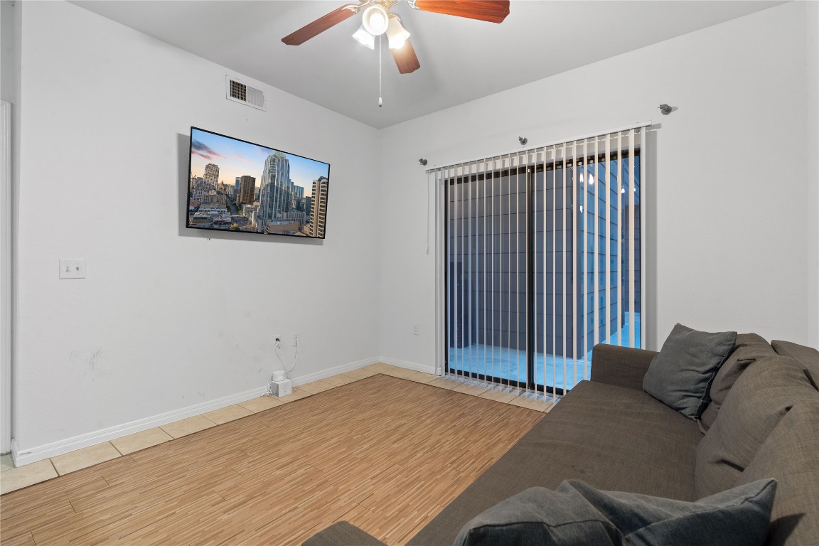 2515 Pearl Street, Unit 508 Austin, TX 78705 - Photo 23 of 25 Living area with light wood-type flooring and ceiling fan