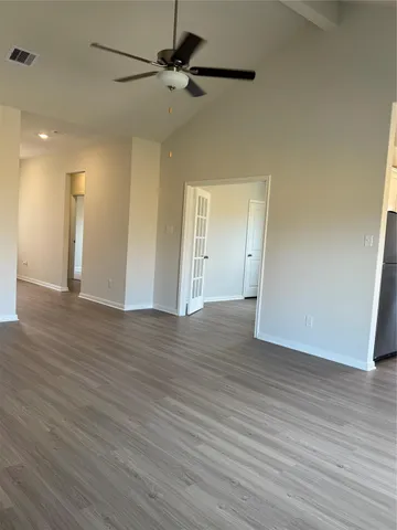 a view of an empty room and wooden floor
