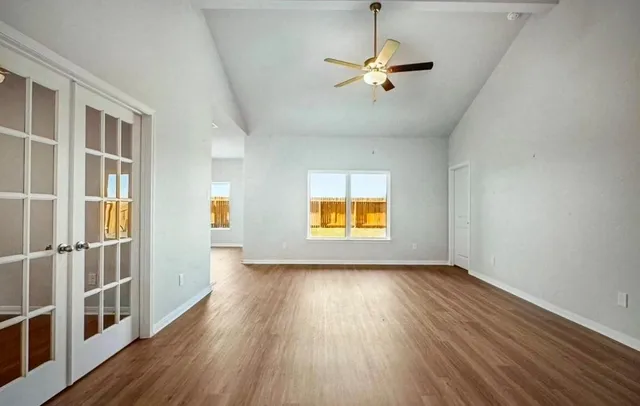 wooden floor in an empty room with a window