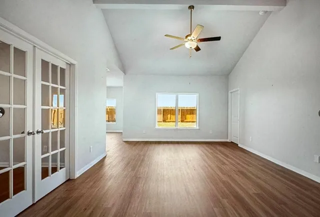 wooden floor in an empty room with a window
