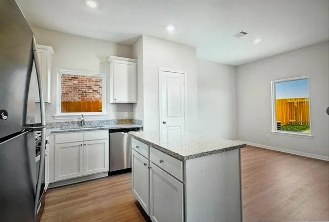 a kitchen with a stove a sink and a refrigerator