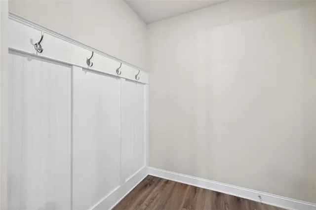 a view of a room with wooden floor