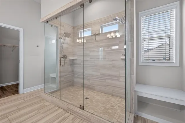 a bathroom that has a glass shower door