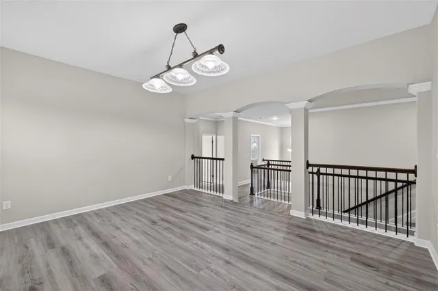 a view of a room with wooden floor