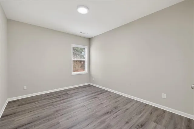a view of a room with wooden floor and white walls