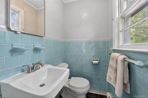 a bathroom with a sink and glass door