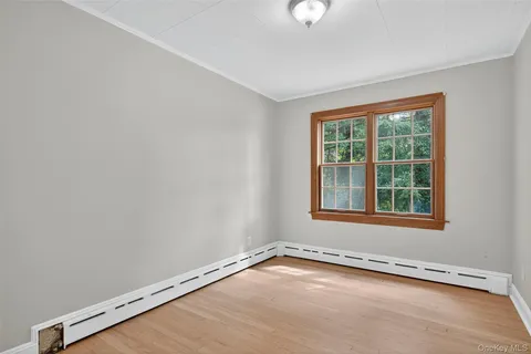 an empty room with wooden floor