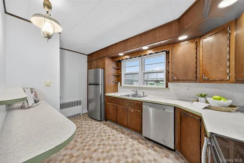a kitchen with a sink appliances and cabinets