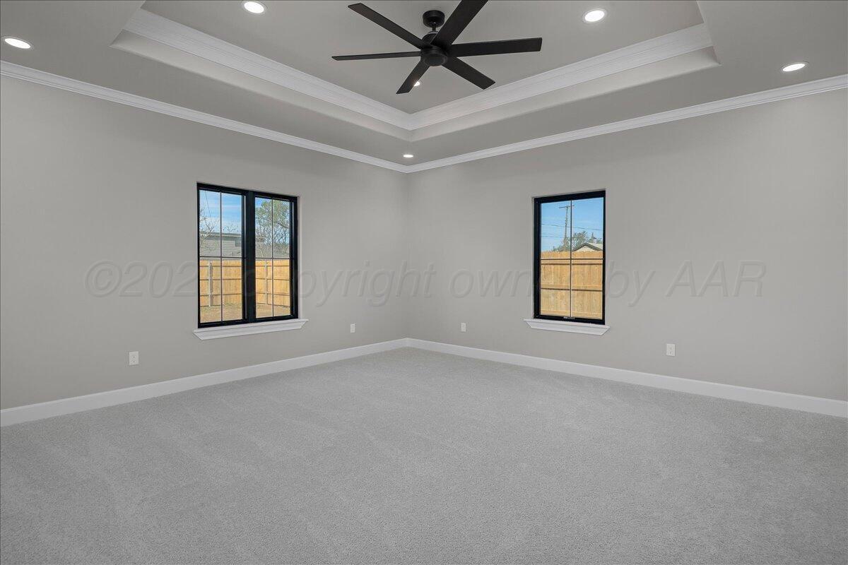 907 Oak Avenue Panhandle, TX 79068 - Photo 13 of 30 en empty room with windows and ceiling fan