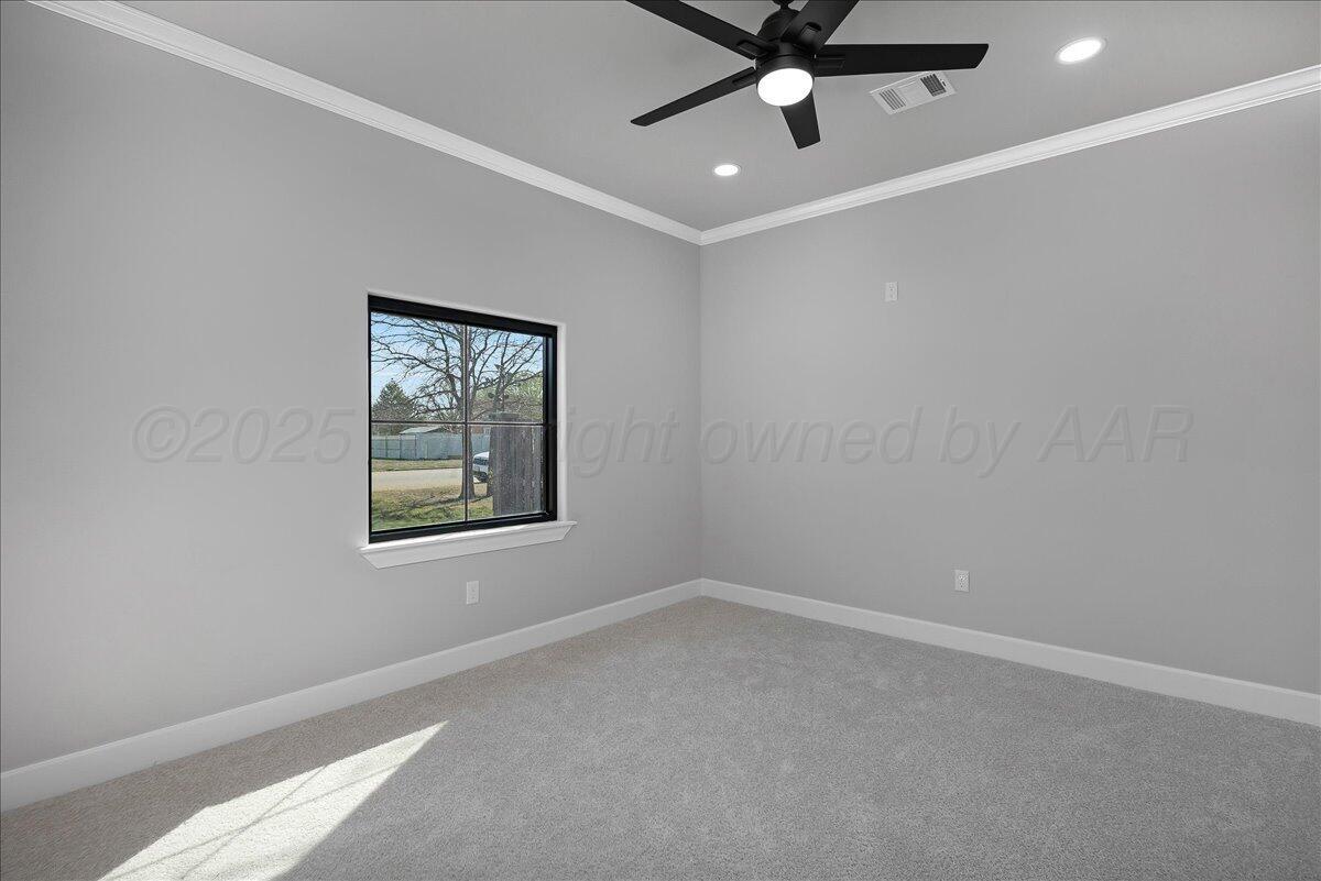 907 Oak Avenue Panhandle, TX 79068 - Photo 19 of 30 an empty room with a window and a ceiling fan
