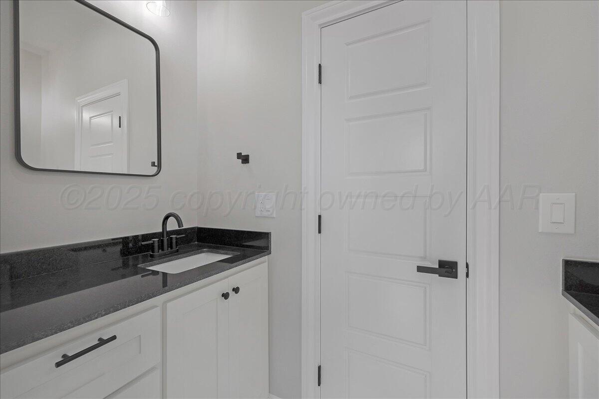 907 Oak Avenue Panhandle, TX 79068 - Photo 22 of 30 a close view of a sink and a mirror in a bathroom