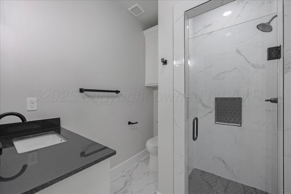 907 Oak Avenue Panhandle, TX 79068 - Photo 26 of 30 a bathroom with a sink and shower