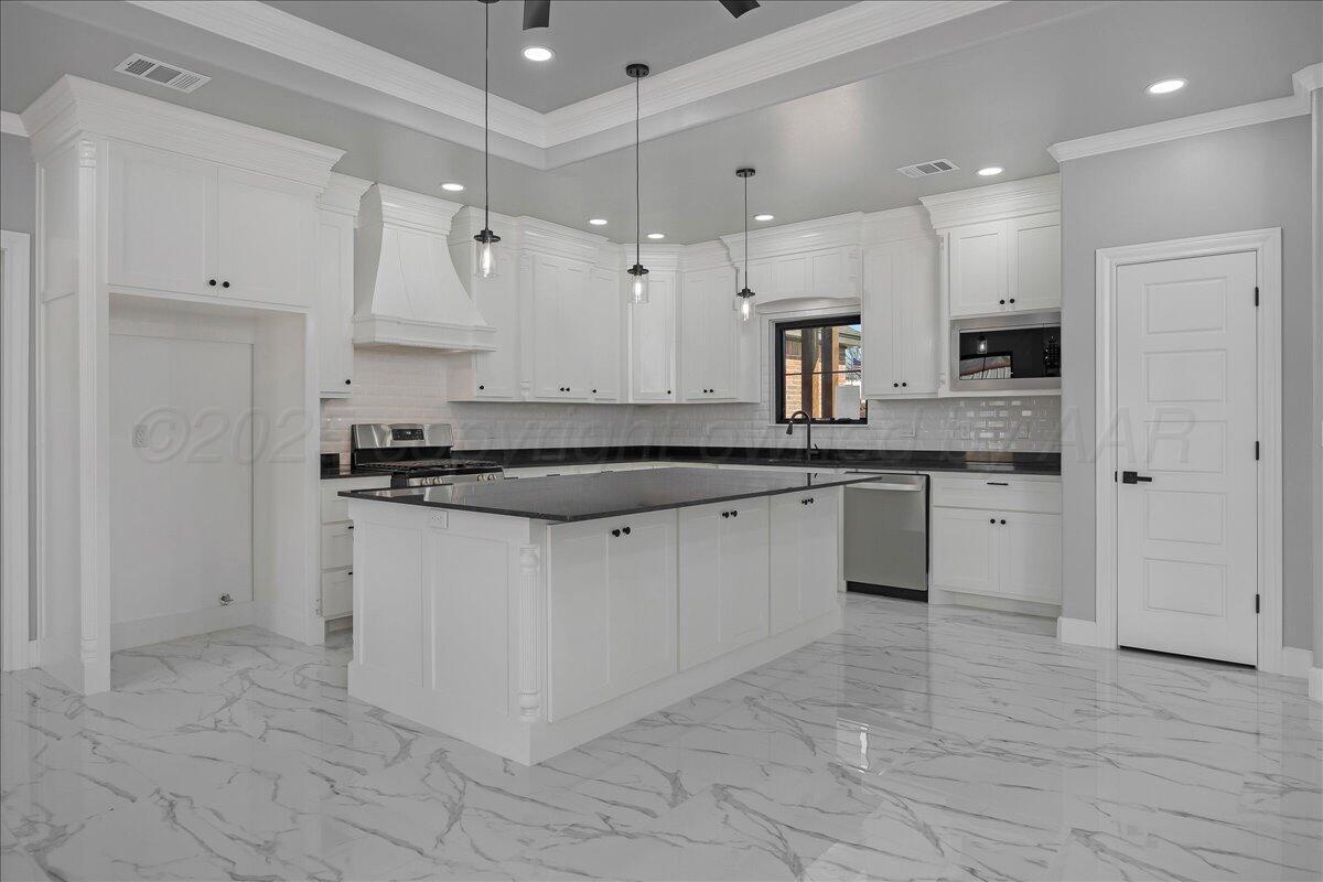 907 Oak Avenue Panhandle, TX 79068 - Photo 9 of 30 a large kitchen with cabinets and stainless steel appliances
