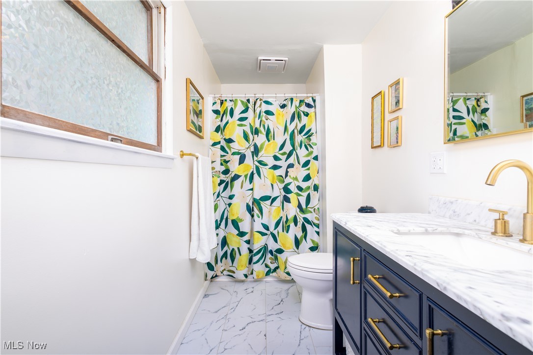 137 Preston Road Steubenville, OH 43953 - Photo 8 of 38 Full bath featuring vanity, toilet, baseboards, marble finish floor, and curtained shower