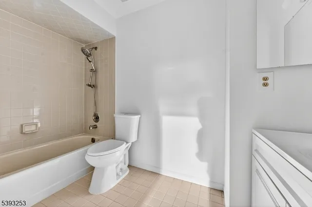 a white toilet sitting next to a bathroom sink