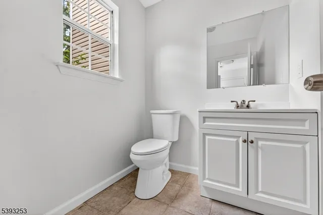 a bathroom with a sink toilet and mirror
