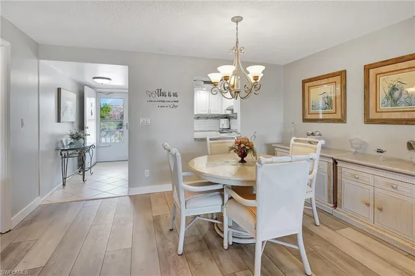a view of a dining room with furniture wooden floor and chandelier