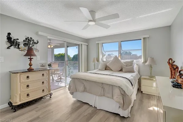 a spacious bedroom with a bed and a dresser