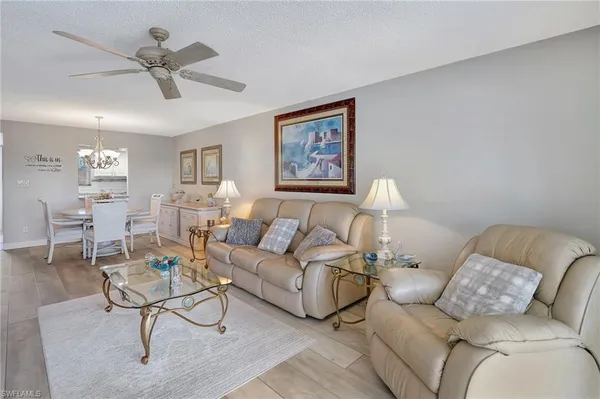 a living room with furniture and a chandelier