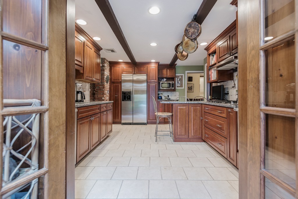 161 Raleigh Tavern Lane North Andover, MA 01845 - Photo 11 of 30 a kitchen with stainless steel appliances kitchen island granite countertop a refrigerator and a stove top oven
