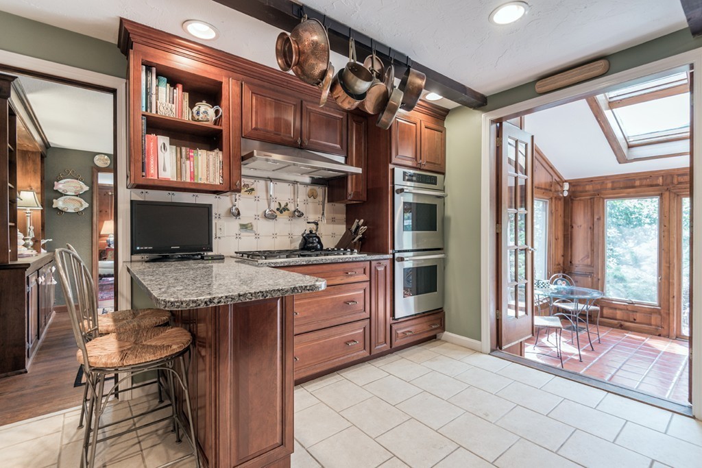 161 Raleigh Tavern Lane North Andover, MA 01845 - Photo 12 of 30 a kitchen with stainless steel appliances granite countertop a stove and cabinets