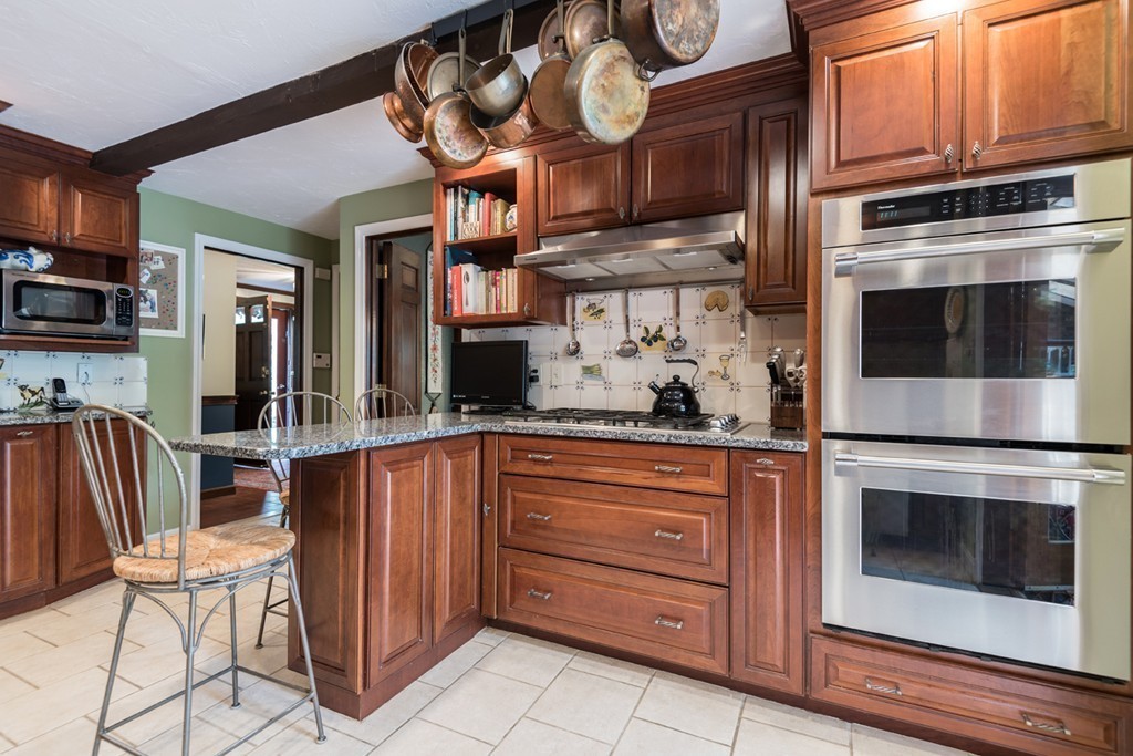 161 Raleigh Tavern Lane North Andover, MA 01845 - Photo 13 of 30 a kitchen with stainless steel appliances granite countertop a stove and cabinets