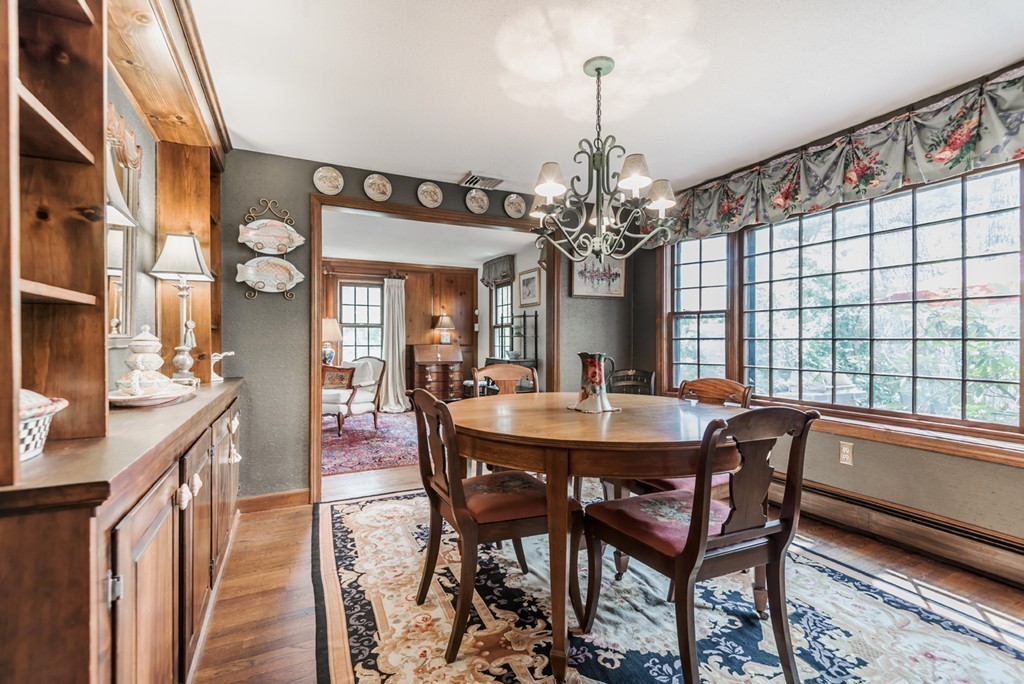 161 Raleigh Tavern Lane North Andover, MA 01845 - Photo 17 of 30 a view of a dining room with furniture wooden floor and chandelier