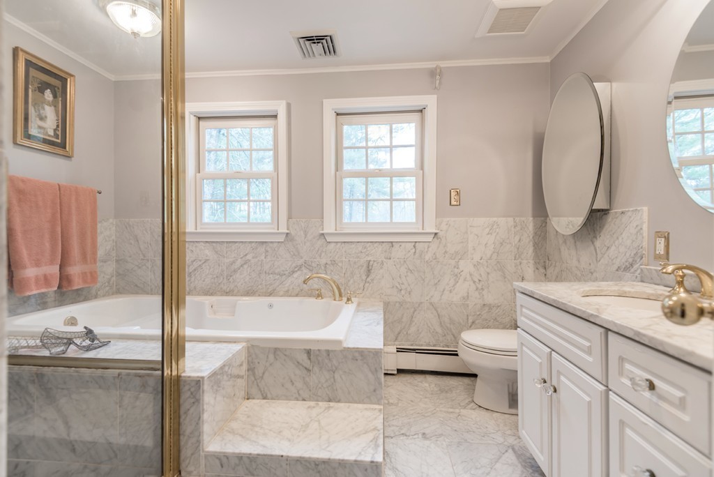 161 Raleigh Tavern Lane North Andover, MA 01845 - Photo 20 of 30 a bathroom with a granite countertop sink and mirror with bathtub
