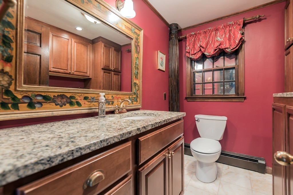 161 Raleigh Tavern Lane North Andover, MA 01845 - Photo 23 of 30 a bathroom with a granite countertop toilet sink and mirror