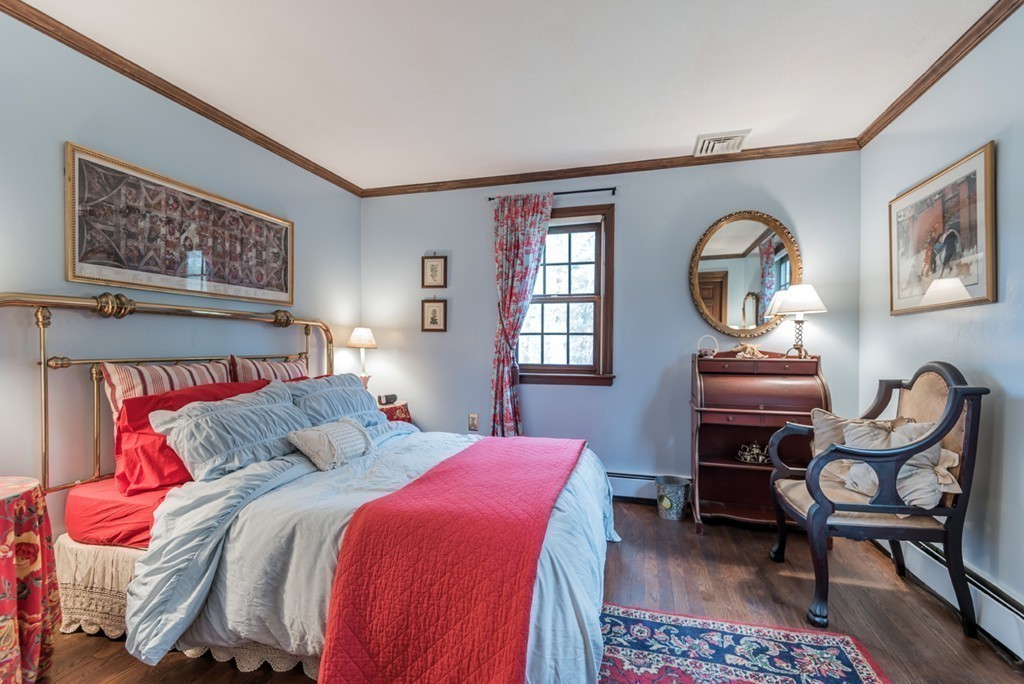 161 Raleigh Tavern Lane North Andover, MA 01845 - Photo 25 of 30 a bedroom with a bed and a chandelier