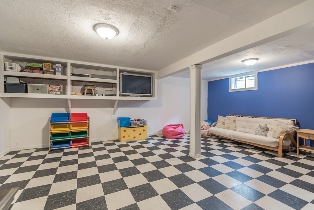 161 Raleigh Tavern Lane North Andover, MA 01845 - Photo 28 of 30 a living room with a black and white checkered floor