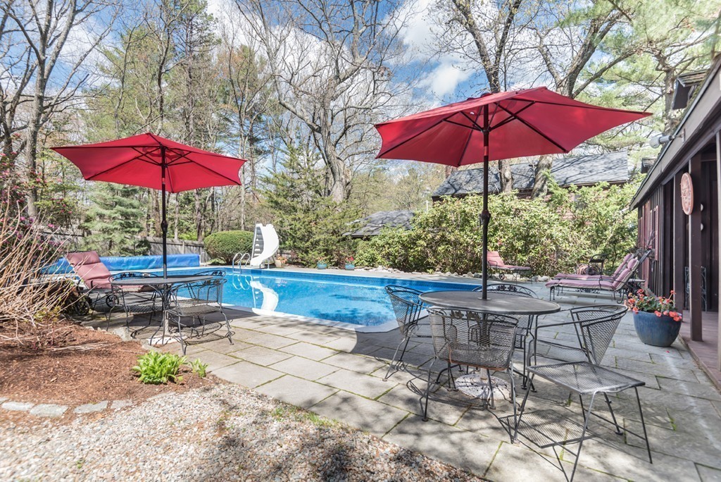 161 Raleigh Tavern Lane North Andover, MA 01845 - Photo 6 of 30 a view of a table and chairs under an umbrella