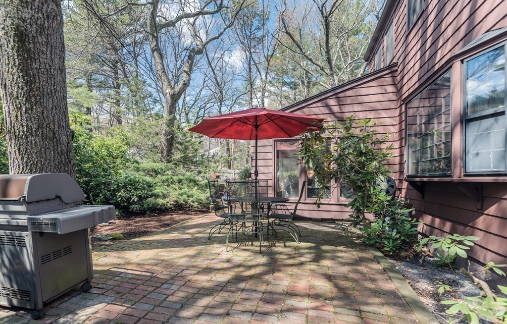 161 Raleigh Tavern Lane North Andover, MA 01845 - Photo 8 of 30 a view of a patio with chairs and tables under an umbrella