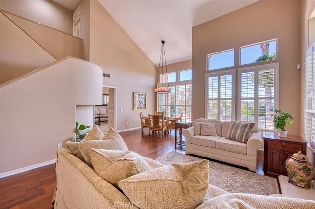 a living room with fireplace furniture and a large window