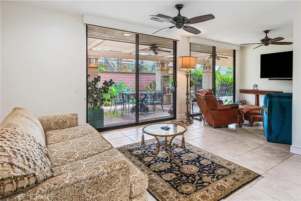 a living room with furniture and kitchen view