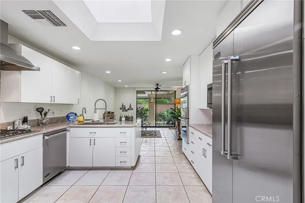 a kitchen with a refrigerator and a stove top oven