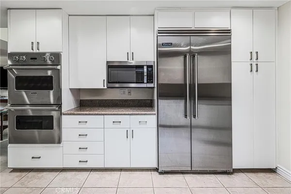 a kitchen with stainless steel appliances granite countertop a sink and cabinets