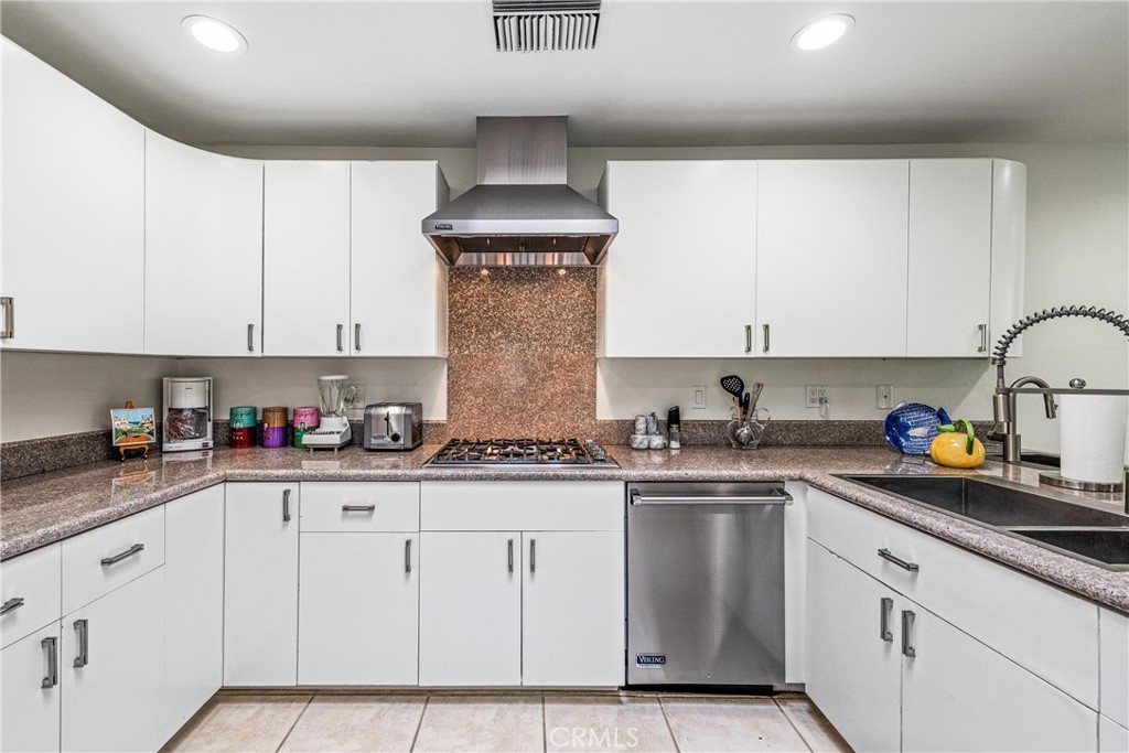 19 Cornell Drive Rancho Mirage, CA 92270 - Photo 17 of 52 a kitchen with stainless steel appliances granite countertop a sink and cabinets