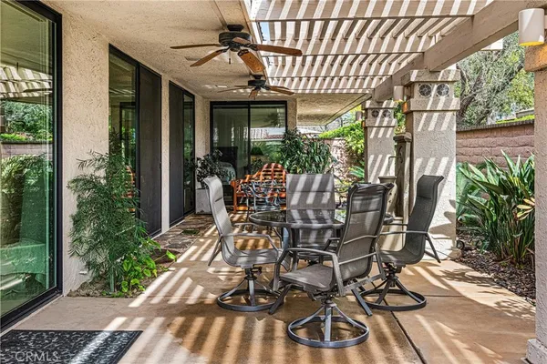 a building outdoor space with patio furniture and potted plants