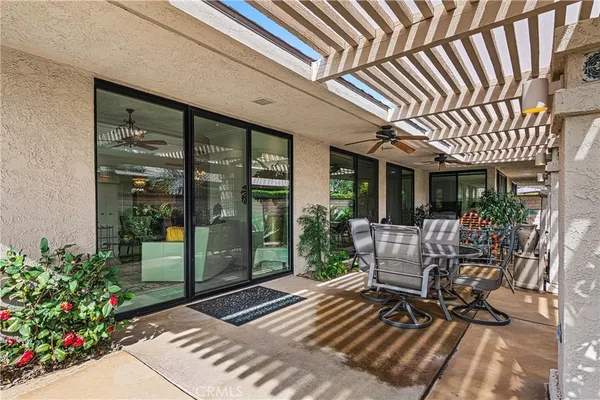 a view of a patio with a table and chairs
