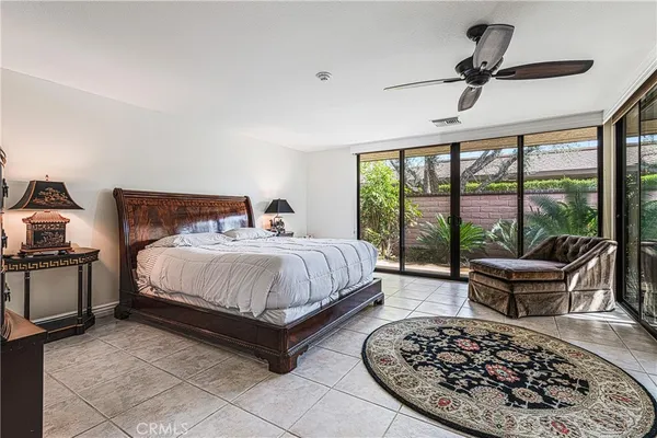 a spacious bedroom with a bed and a large window
