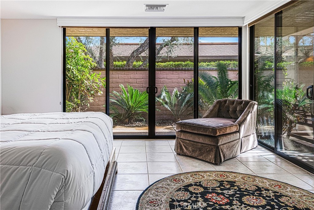 19 Cornell Drive Rancho Mirage, CA 92270 - Photo 29 of 52 a spacious bedroom with a bed and a large window