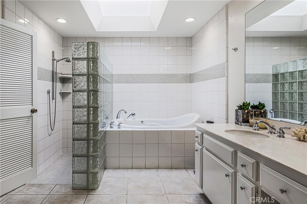 19 Cornell Drive Rancho Mirage, CA 92270 - Photo 32 of 52 a bathroom with a bathtub shower sink and mirror
