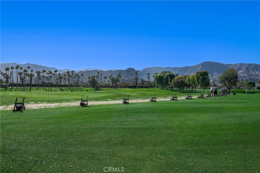 19 Cornell Drive Rancho Mirage, CA 92270 - Photo 49 of 52 a view of a grassy field with mountains in the background
